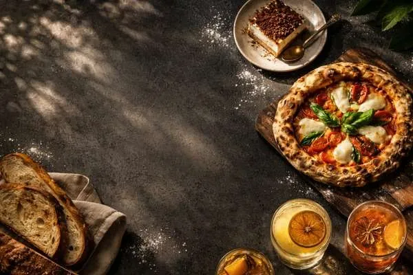 Mesa servida en Figata con pizzas recién horneadas y ambiente cálido